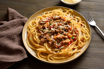 Delicious spaghetti pasta dish with meaty tomato sauce, made with beef and pork, onions, tomato, and herbs