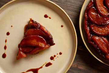 Slice of apple tarte Tatin with sweet caramelized red apples and sugar caramel