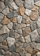 Obraz premium Close-up of natural stone masonry, rustic rock texture with organic patterns and earth tone colors, decorative stone surface for architecture, construction, and interior backdrop.