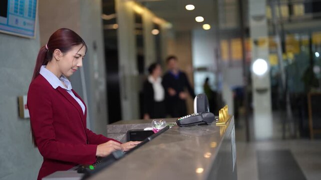 Business vacation couple entering hotel reception area, confirming booking, paying with credit card while receptionist works behind counter. Scene ends with guests departing after successful check in.