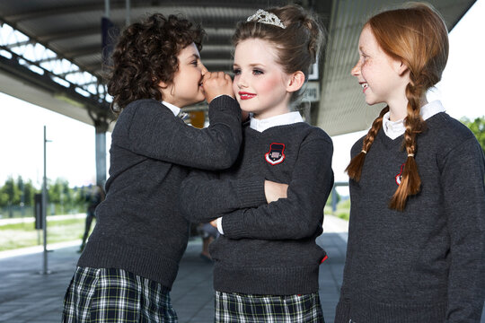Three girls at platform wearing school uniform