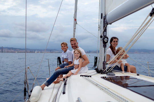 Family sitting on deck during sailing trip