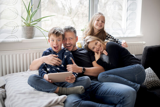 Portrait of playful family on couch at home