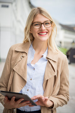 Portrait of smiling young businesswoman with tablet