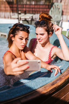Two women taking a selfie in a jacuzzi