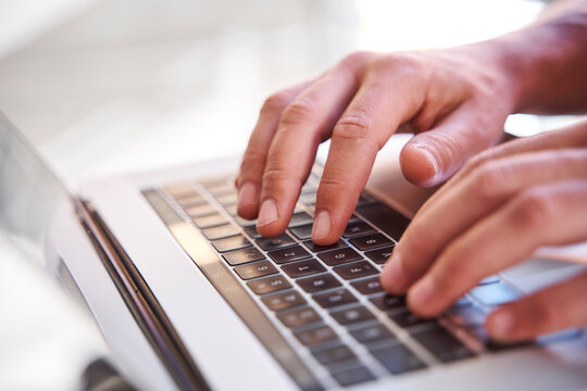 Businessman using laptop, close-up