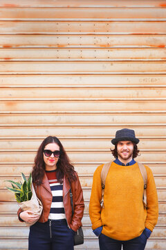 Portrait of young couple standing side by side