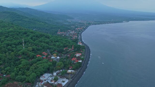 Aerial view of amed coastline with mount agung volcano in bali