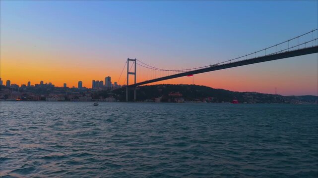 A beautiful view of the 15 July Martyrs Bridge (15 Temmuz Sehitler) silhouette at sunset in the evening, Turkey, Istanbul.  Bosphorus bridge.