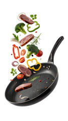 Frying pan with meat and vegetables falling into it isolated on a transparent background