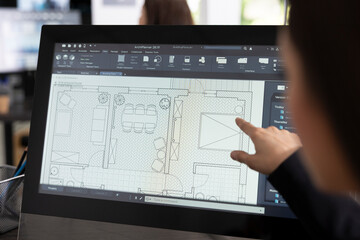 Female creative designer sketching architectural floor layout on digital device, preparing for new...