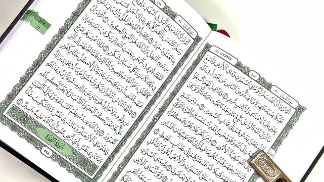 Quran Reading: An open Quran, revealing intricate calligraphy and sacred verses, rests on a table, symbolizing spirituality and devotion.