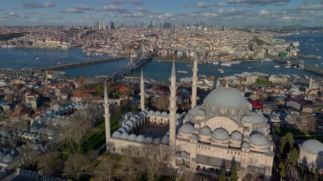 Aerial drone view of the historic Golden Horn in Istanbul, showing the Suleymaniye Mosque, Galata Bridge and the Bosphorus. Galata Tower and Taksim Square in the distance.