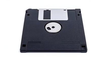 A vintage, close-up photograph of a black square floppy disk on a white surface