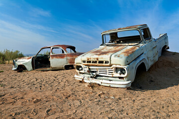 Classic cars rust in desert landscape of Namibia near Nef