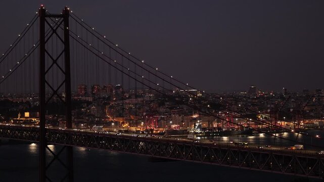 Night time traffic over Tagus river bridge in Lisbon, Portugal