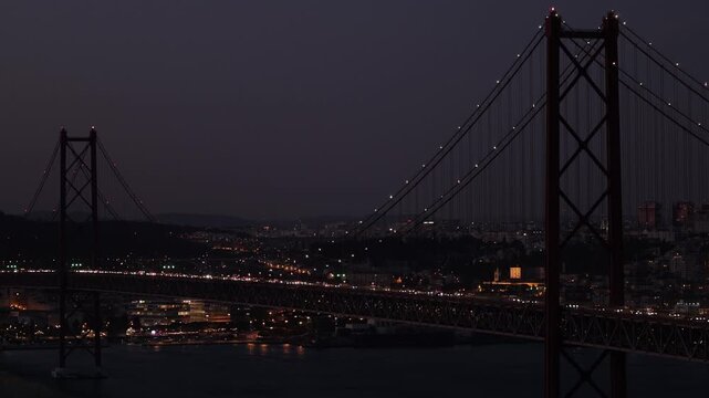 Night time traffic over Tagus river bridge in Lisbon, Portugal