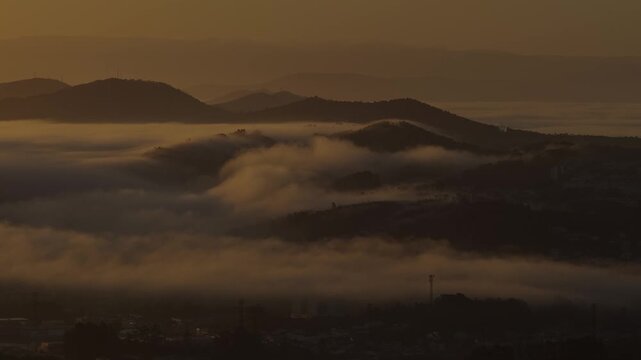 Thermal inversion with rolling clouds on the mountains in Portugal