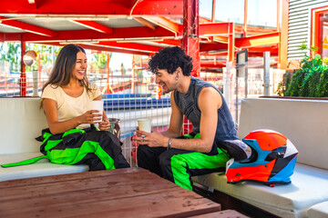 Young couple enjoying post karting break and fun conversation