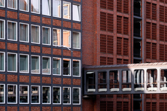 Modern architecture office with brick windows and skybridge in Speicherstadt Hamburg Germany linking urban buildings in daylight scene