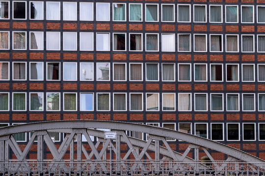 Urban architecture of brick building facade with windows pattern in Speicherstadt Hamburg Germany creating repeated grid texture in daylight