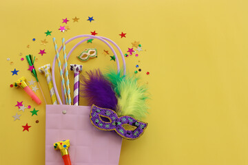 masquerade celebration concept over yellow background