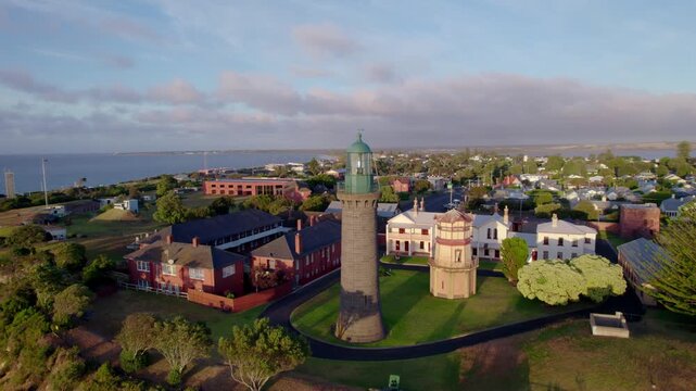 Aerial circling historic military base and black lighthouse, Queenscliff