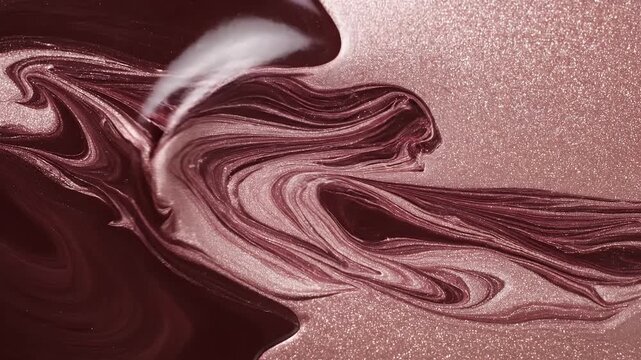 Swirling viscous textures of deep maroon and shimmering rose gold glitter