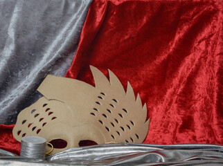 Background with a cardboard mask and red velvet