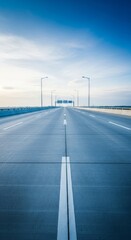 Ultra-wide multi-lane concrete expressway viewed during bright daylight with strong receding perspective leading to an open horizon, receding, perspective, ultra-wide