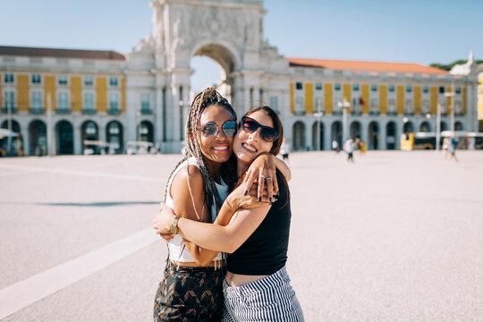 Happy women embracing each other at Praca Do Comercio, Lisbon, Portugal