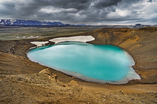 Krafla caldera shows blue water near volcanic landscape in Iceland