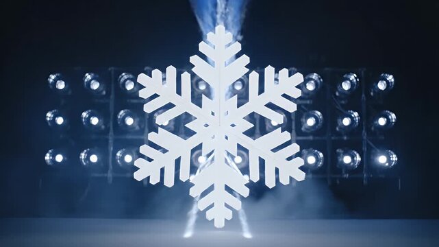 Giant snowflake centered amidst blue laser beams and smoke effects