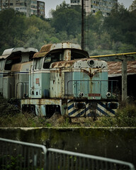 Old abandoned locomotive in industrial area.