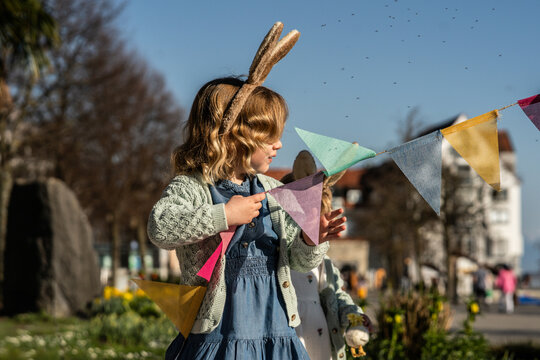 Girl with bunny ears celebrating Easter outdoors