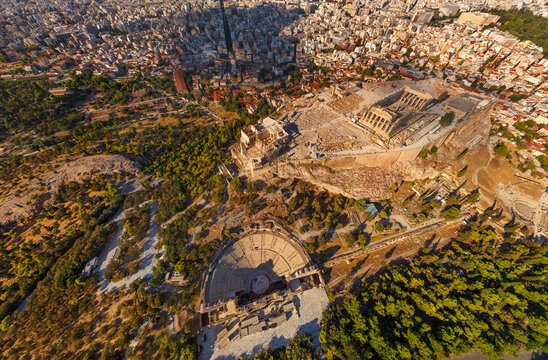 Aerial view of the ancient Acropolis crowned by the Parthenon, the Odeon of Herodes Atticus below, contrasting with the modern city sprawl, Athens, Central Athens Regional Unit, Greece.