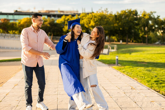 Graduate friends celebrating in a joyful moment