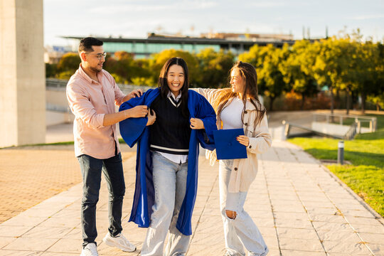 Friends celebrating graduation outdoors