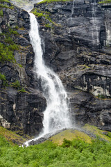A waterfall falling from a high slope © KoshMara