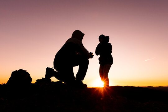 Romantic marriage proposal during sunrise adventure