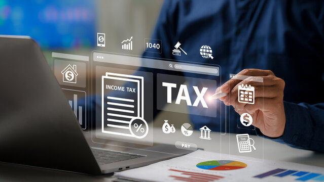 Online tax payment concept. Businessman hand using stylus pen touching virtual screen with "TAX" word and Income tax return form 1040. Financial research and calculation for government state taxes.