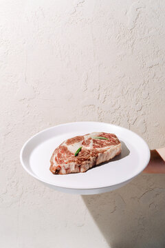 Wagyu beef ribeye steak on a white plate
