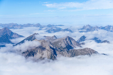 Obraz premium Mountains in the Alps Pushing Through Undercast on Zugspitze Mountain Germany