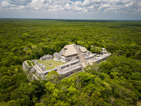 Aerial view of the ancient Mayan ruins of Ek' Balam rise majestically from the dense jungle, bathed in sunlight, a testament to a rich history, Chichen-Itza, Yucatan, Mexico.