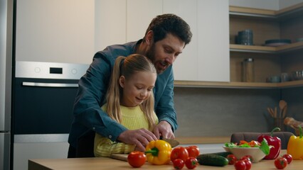 Family cooking together at home kitchen caring father helping teaching Caucasian kid daughter...