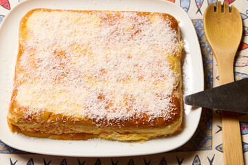 Carrot cake. Glass dish with a cake made with coconut, carrots, and brioche buns.