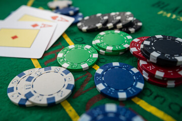 Pair of aces in poker game with casino chips on green felt background