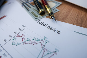Business Analytics Concept with Total Sales Statistics Growth Chart and Dollar Bills