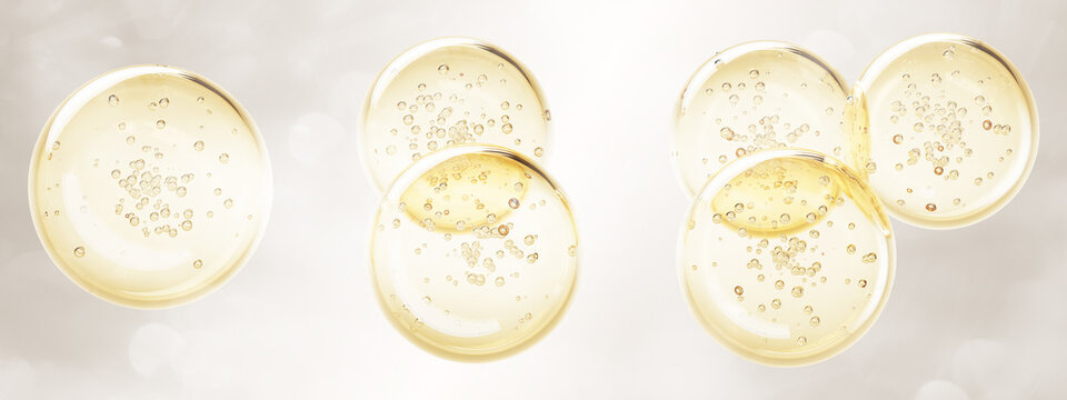 Golden oil drop texture with bubble 3d render icon set. Yellow liquid collagen gel sphere, gold serum circle stain top view. Keratin cosmetic fluid puddle on light beige background. 3D illustration