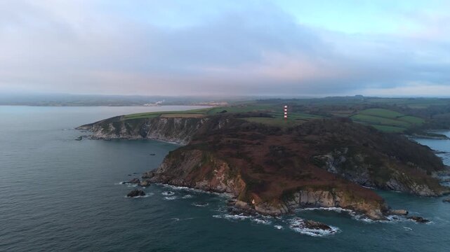 Aerial view of the Gribbin Daymark standing tall on the rugged coastline, contrasting with the calm sea, Fowey, England, United Kingdom.
